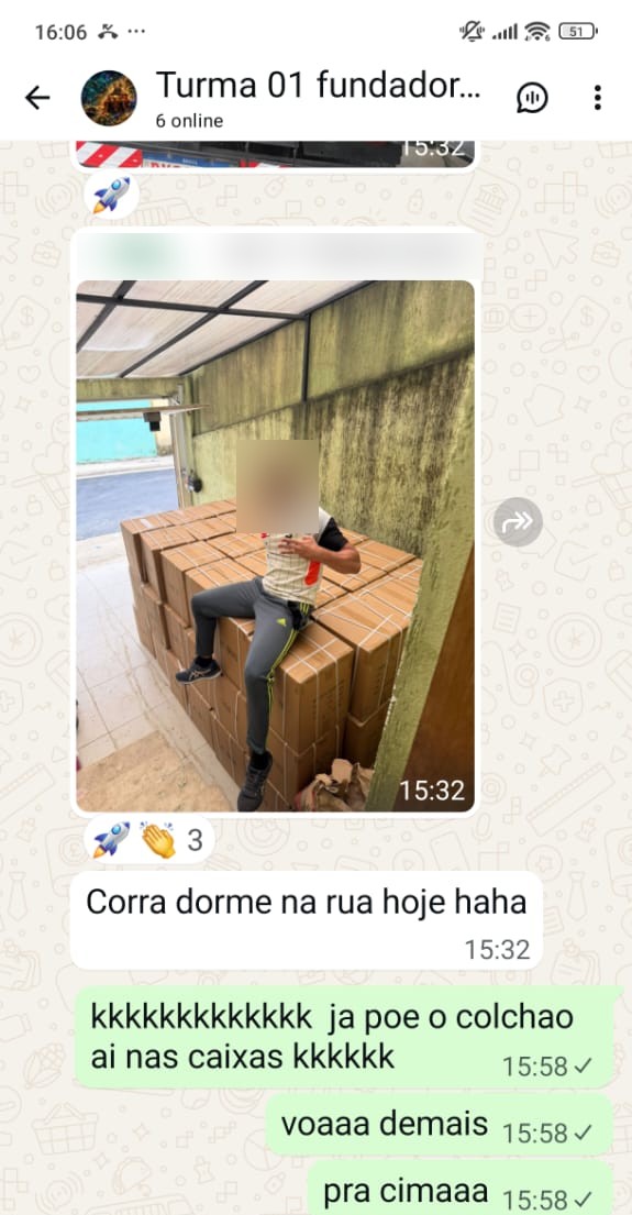 Aluno sentado em cima de uma pilha de caixas da importação que acabou de chegar